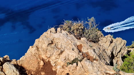 vantage point from cliffs overlooking a deep blue sea at navagio beach