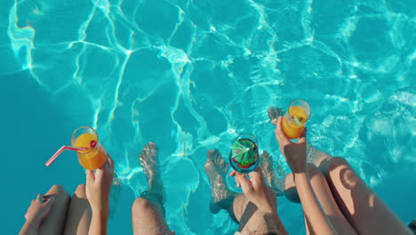 friends enjoying drinks in a pool