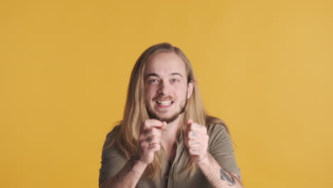 caucasian young man celebrating in front of the camera.