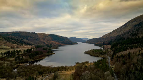 Witness-the-enchanting-Cumbrian-landscape-through-captivating-drone-footage,-revealing-Thirlmere-Lake-surrounded-by-majestic-mountains