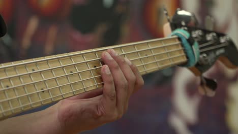 Close-Up-of-an-Electronic-Guitar-Strings-Being-Playing-by-a-Man-in-a-Studio