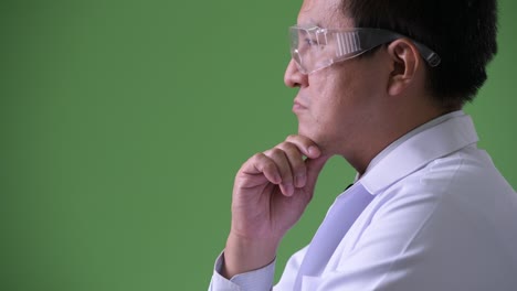 mature japanese man doctor wearing protective glasses