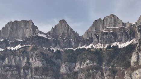 Dramatic-peaks-of-Churfirsten-over-Walensee-in-the-heart-of-Switzerland---aerial-pan