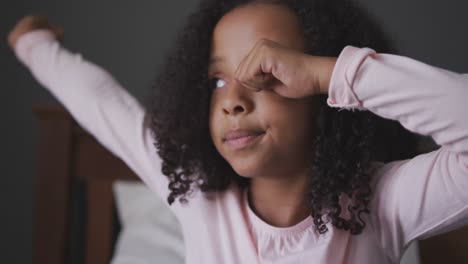 african american girl stretching in her bed