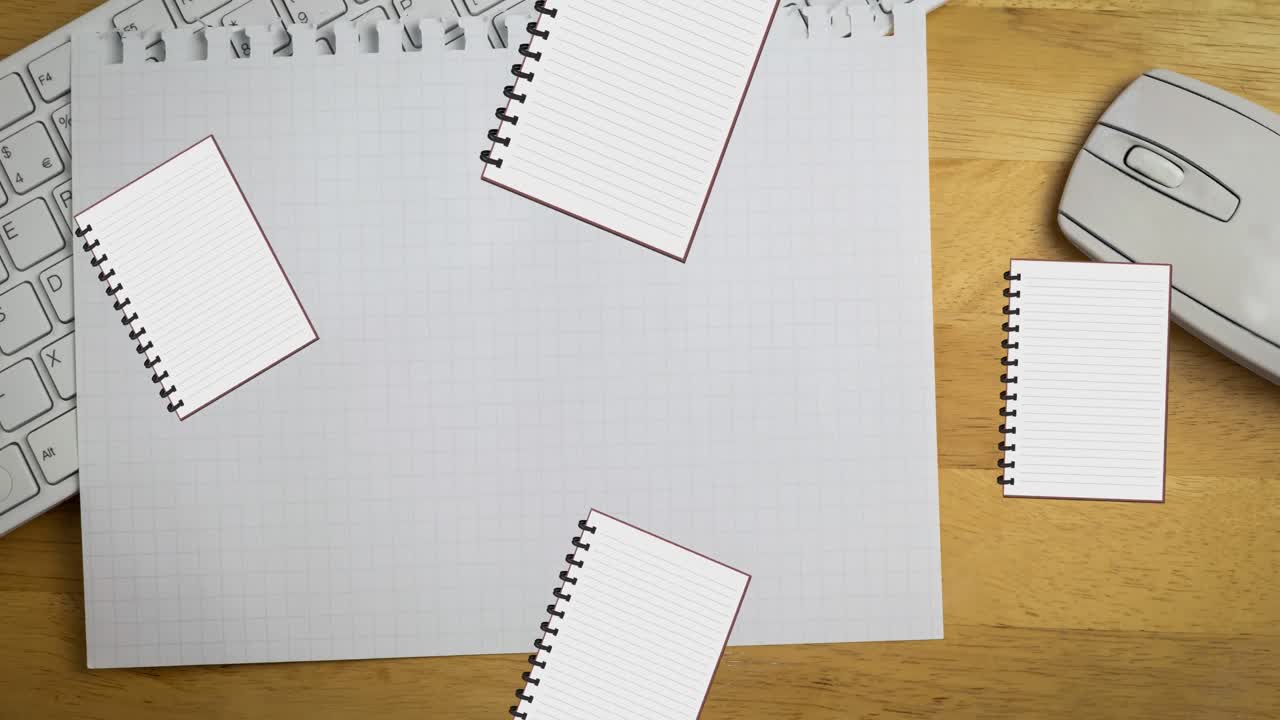 Animation of notebook digital icons over notebook on desk