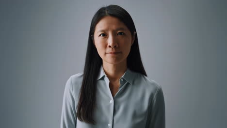 Portrait of an Asian Woman with a Neutral Expression