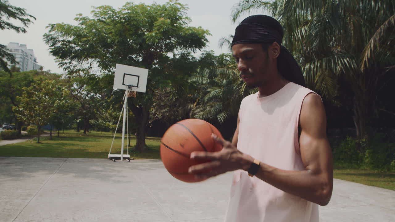 Young Sportsman Checking Pulse on Smartwatch after Streetball Training