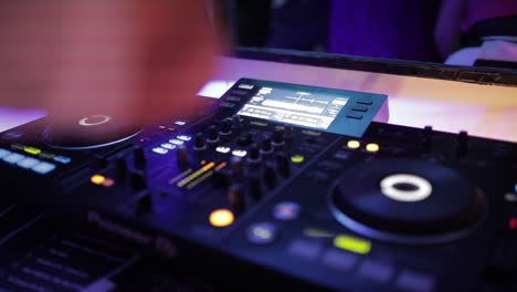 crop dj using controller during party in club