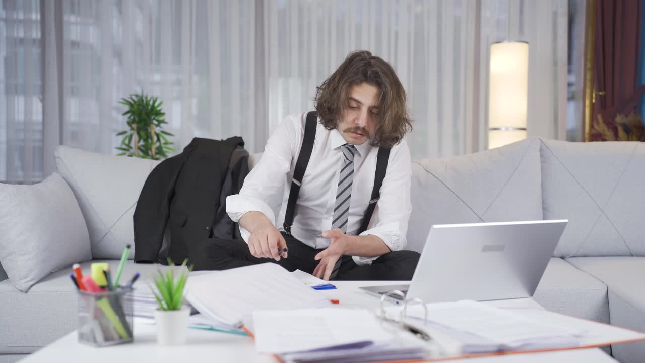 Tired businessman trying not to sleep.