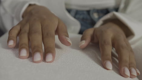 close up view of woman hands touching a book