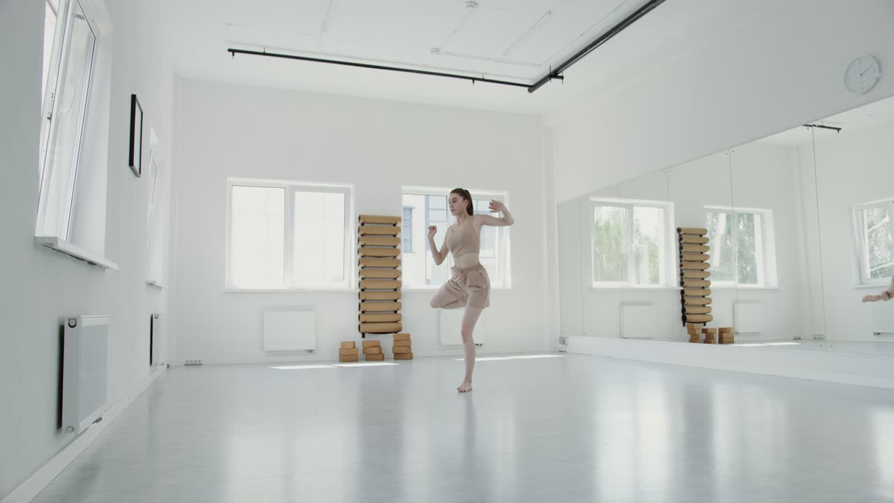 Woman doing yoga exercises in a studio