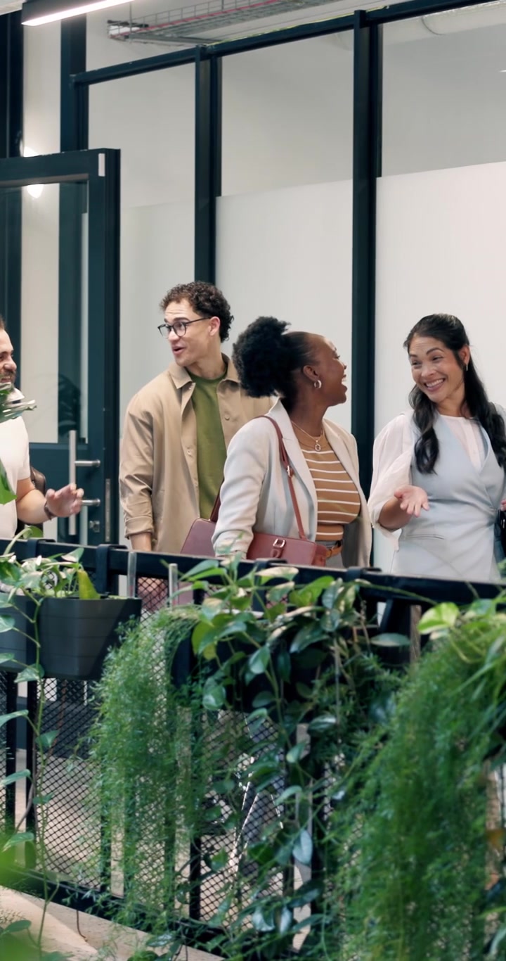 Diverse Group of Colleagues Talking in Modern Office Hallway