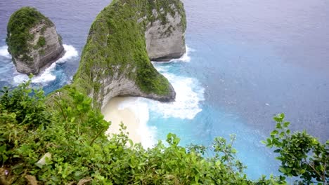 Beautiful-shot-overlooking-lush-greenery-and-large-stone-structures-at-Kelingking-Beach