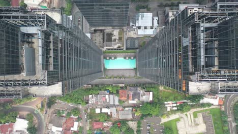 high-rise building with rooftop pool, aerial view