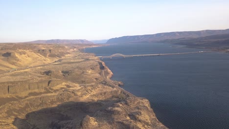 drone with arial view of highway, river and bridge