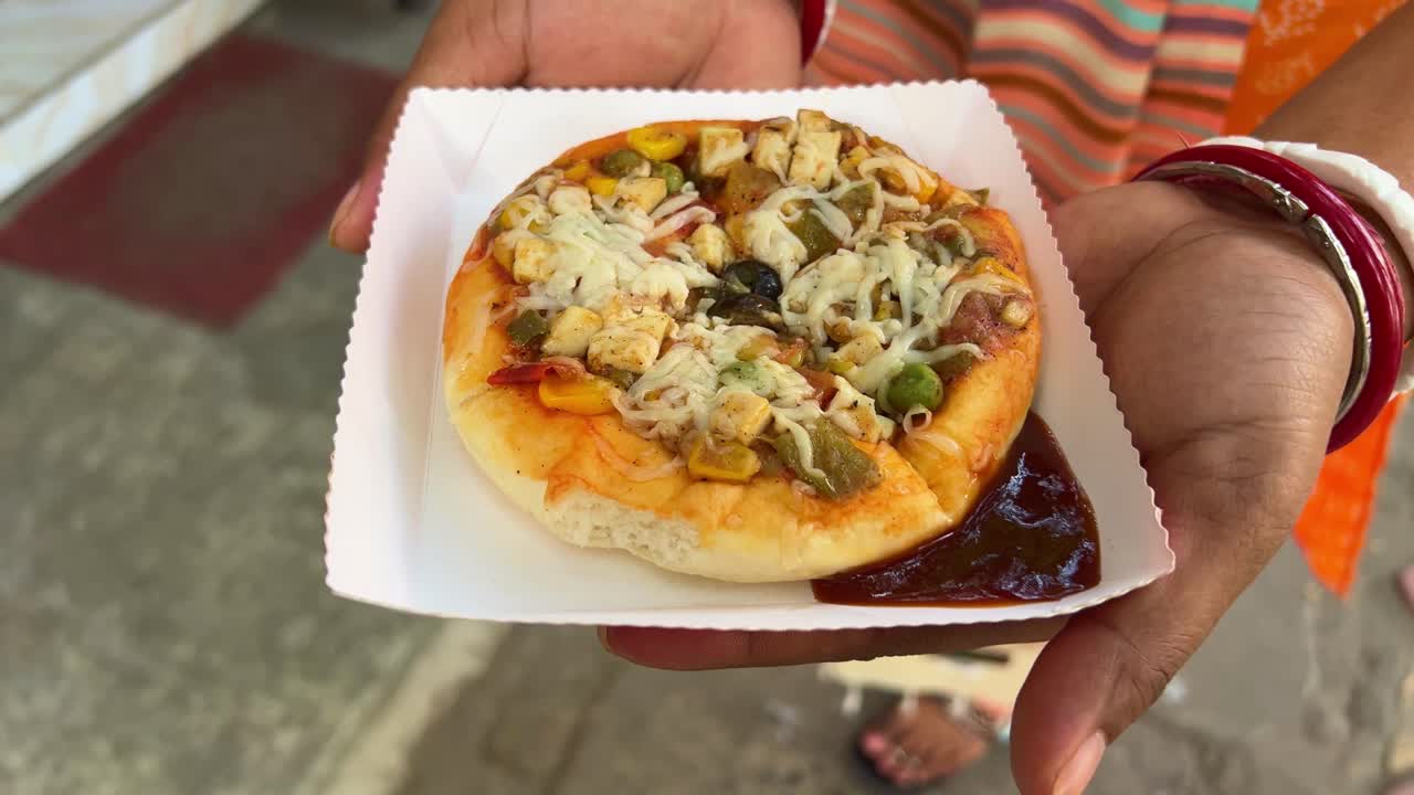 Closeup view of small veg pizza with tasty toppings.