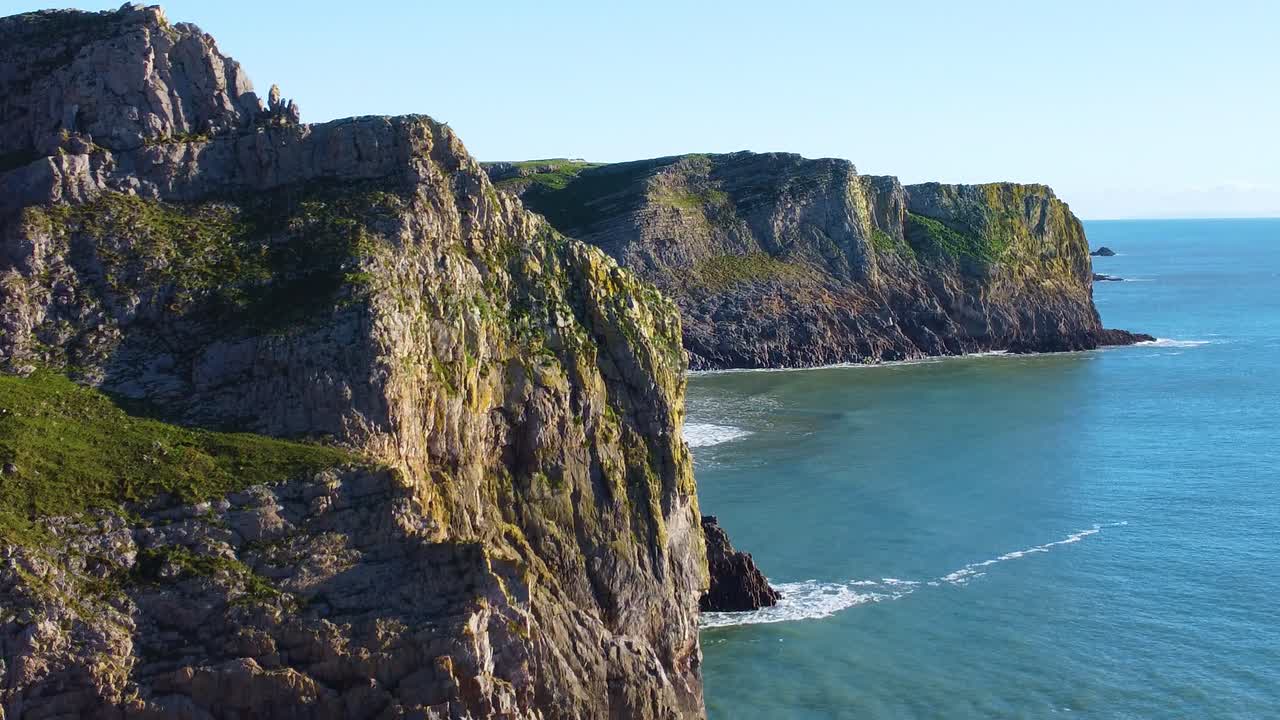 Dramatic Fly Over Rocky Coastal Cliffs in South Wales UK. Travel Nature Drone Clip. Beautiful Welsh Gower Peninsula Coast. Establishing Opening Shot