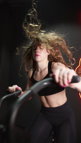 woman exercising on an indoor cycling machine