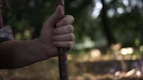 hands holding a wooden stick medium up shot