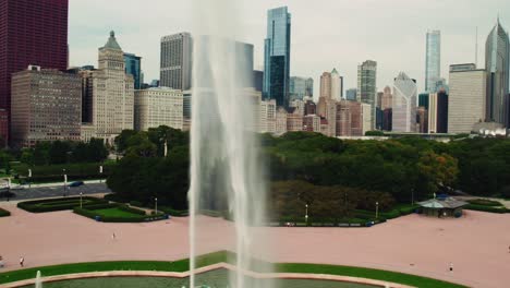 sliding beautiful aerial of chicago scenary while buckingham fountain shooting with high pressure water in slow motion