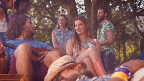 in high quality format handsome hipster relaxing on campsite