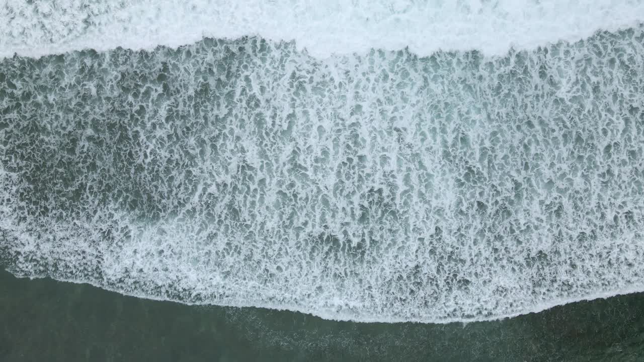 Top down view of waves of turquoise sea water