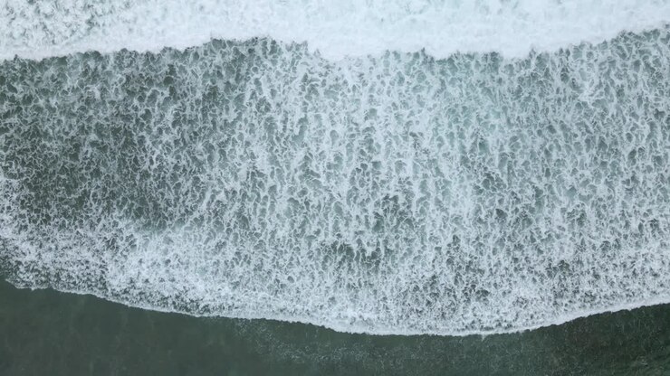 Top down view of waves of turquoise sea water