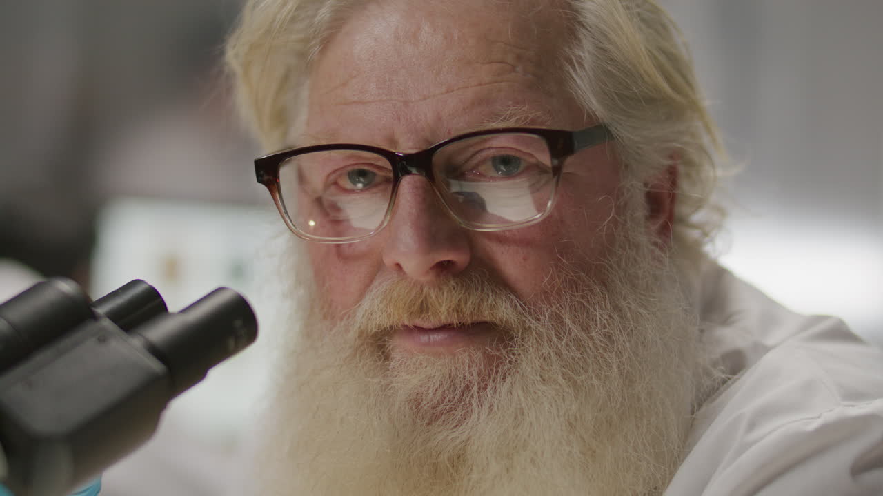 Portrait of Elderly Scientist Using Microscope in Laboratory