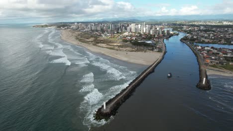 orbital movement with drone circling two navy lighthouses on brazilian beach, soft dawn light