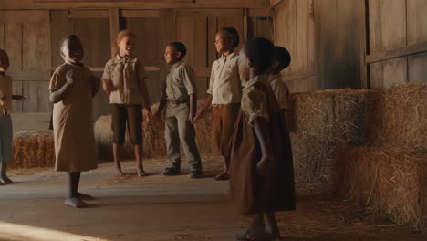 Children playing in a vintage barn