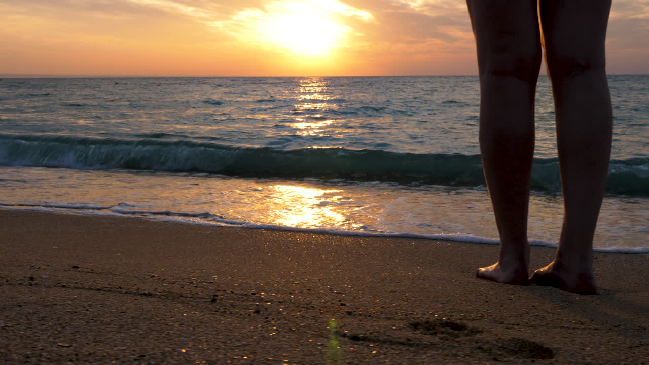 Woman feet on the beach relaxing in the water