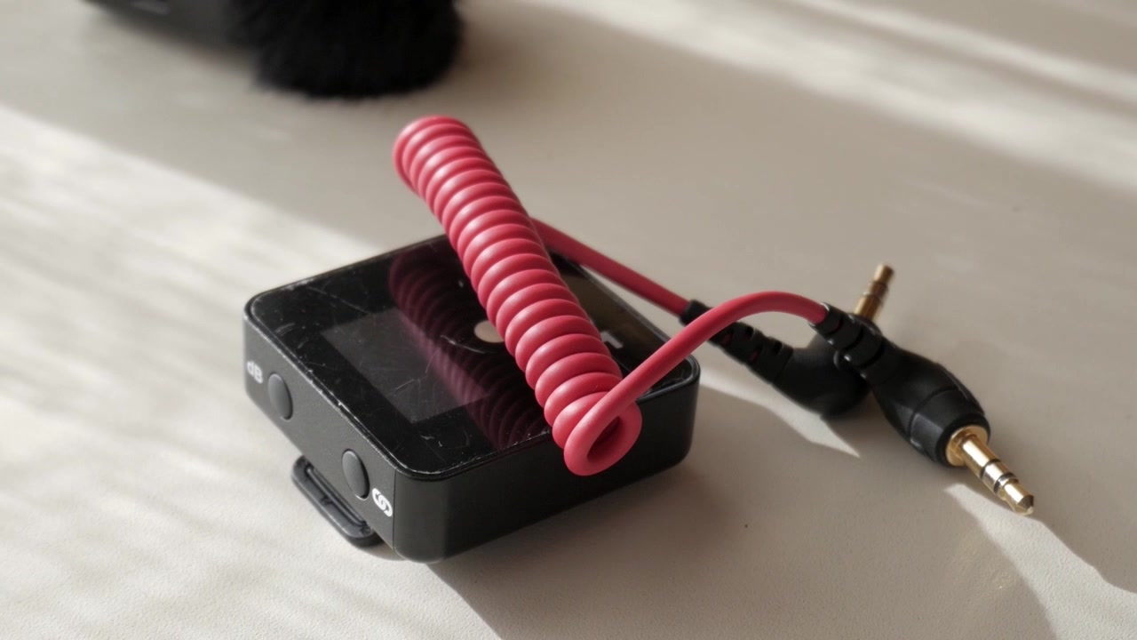 Close-up of lavalier mic setup on bright surface for recording audio