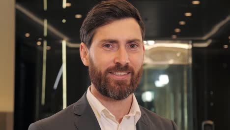 portrait of young adult happy smiling business man executive looking at camera. banker male professional coach teacher, bearded entrepreneur or manager posing in office hall, close up face headshot.