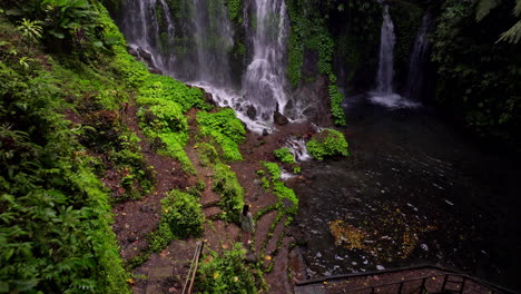 Water-from-above-forming-frothy-cascade,-spraying-mist-into-the-air