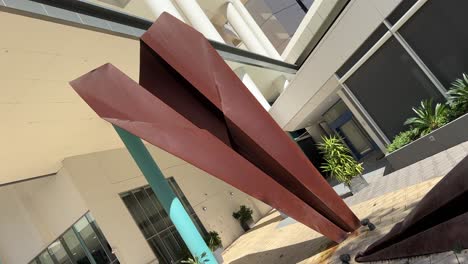 Giant-Paper-Aeroplane-art-sculpture-made-of-rusted-metal-on-Adelaide-Tce,-Perth,-Western-Australia