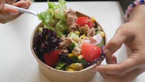 person eating a tuna salad