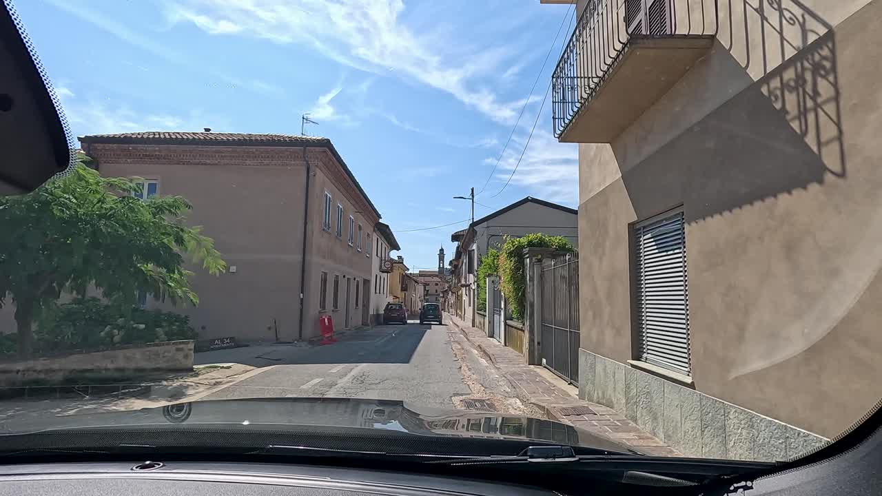Car navigates colorful, narrow streets in Piedmont