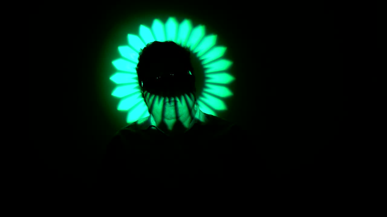 Portrait of a fat man in a multicolored light beam.