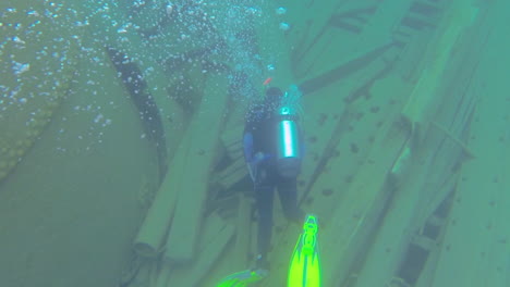 Following-a-diver-as-he-explores-the-underwater-wreckage-of-a-sunken-ship