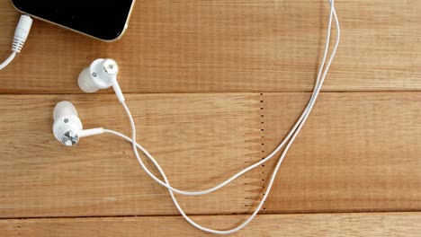 close-up of mobile phone with headphones