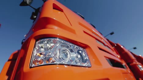 close-up of an orange truck's headlights