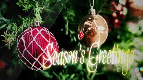 christmas ornaments on a tree with season's greetings