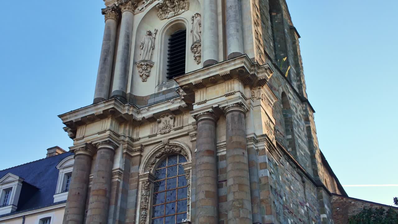 Tall tower of Church of Notre Dame Saint Melaine establishing tilt down. Rennes in Brittany