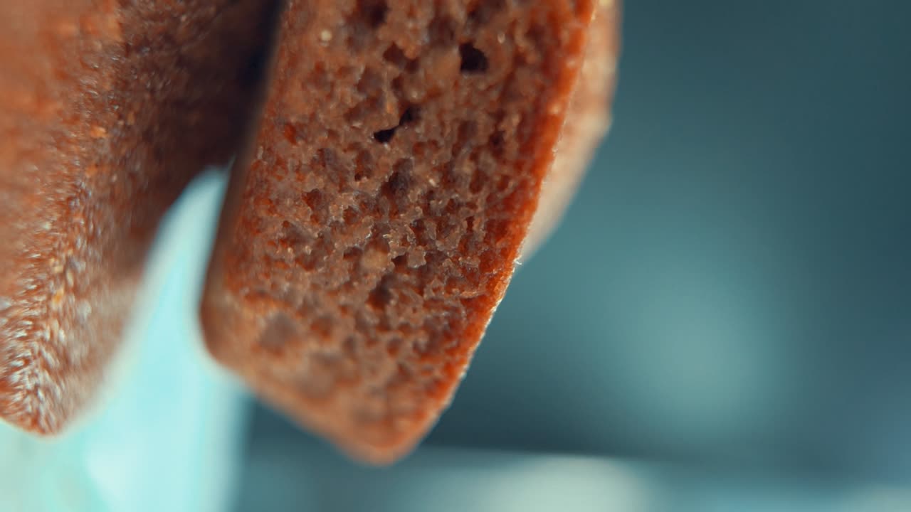 A vertical macro close up shot of tasty cupcakes, on a 360 rotating stand, studio lighting, super slow motion, 120 fps, smooth movement, Full HD Video