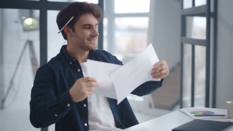 closeup angry business man throwing documents away. guy checking papers