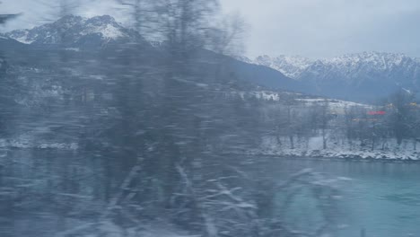 window shot of landscape train during severe winter