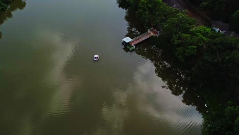 High-jib-up-of-a-single-pedal-boat-on-a-vast-lake-in-Abuja,-Nigeria