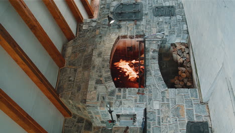 burning stone barbecue firewood with fire open brick oven for cooking food meat fish in backyard