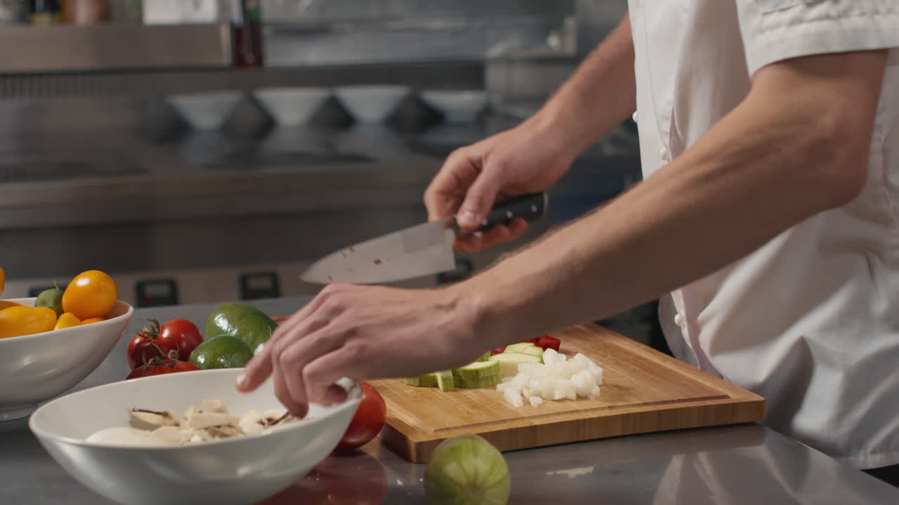 Cook Cutting Vegetables At Commercial Kitchen