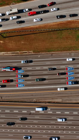 private transport going by the multi-lane roads. top view on the highway at daytime. vertical video